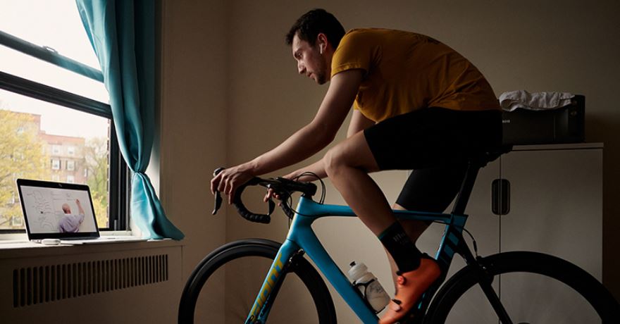 student on bicycle while learning online