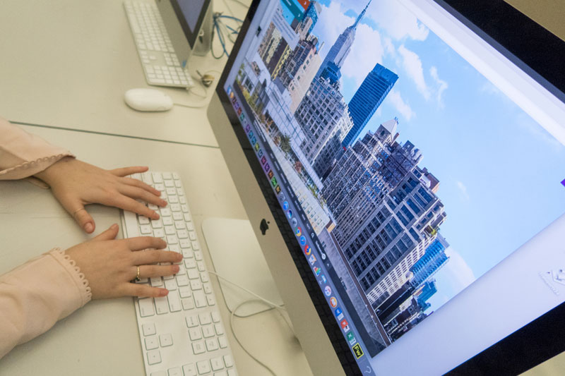 Hands typing at a computer 