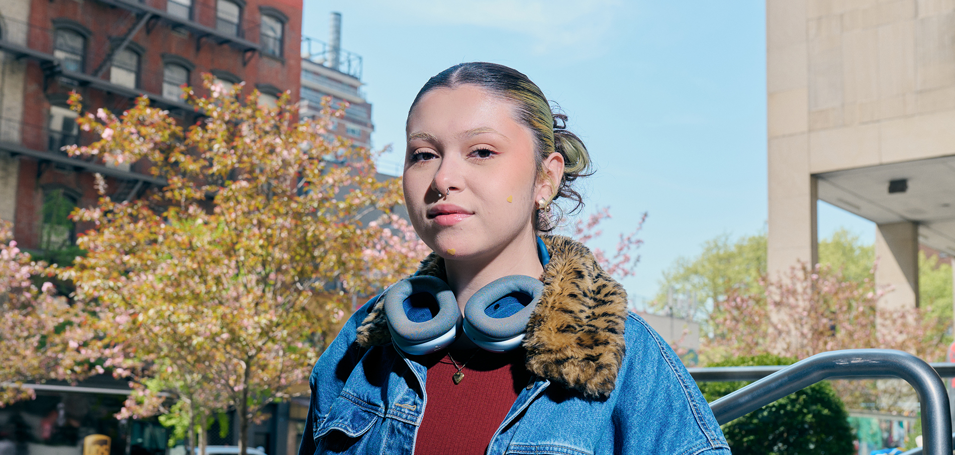 FIT students with headphones outdoors on campus