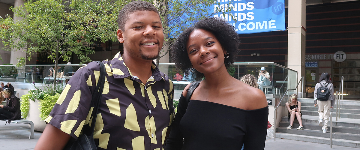 two BIPOC FIT students smiling outdoors on campus