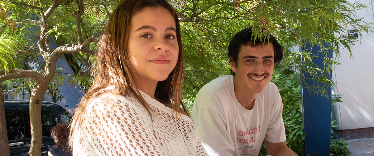 two BIPOC FIT students sitting outdoors on campus