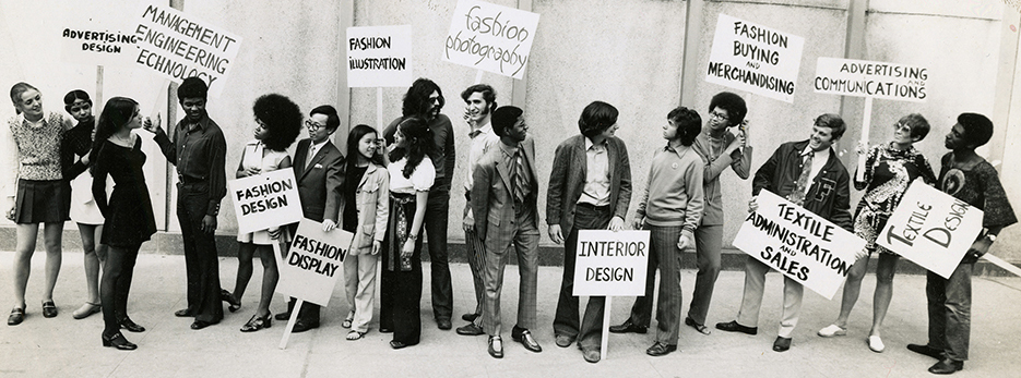 Students holding signs with programs names outside of FIT.