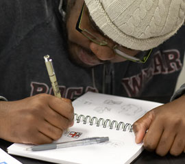 student drawing in a sketch book