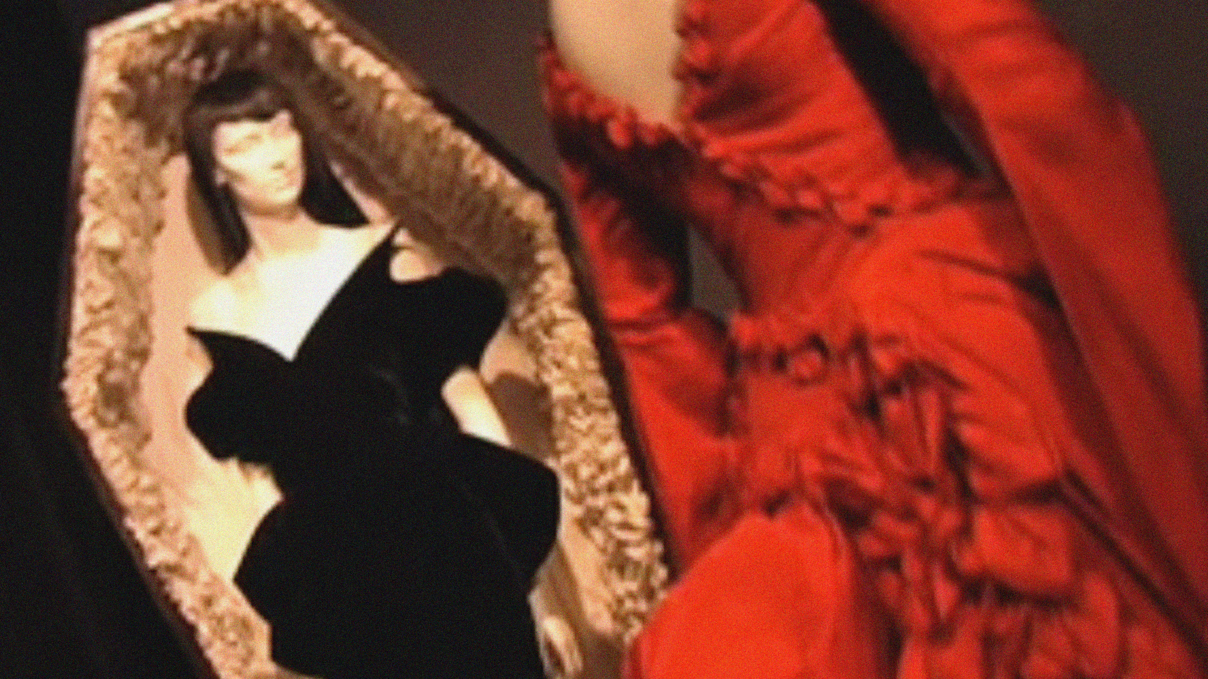 thierry mugler black velvet dress on a mannequin in an open coffin with another mannequin in a red dress outside the coffin