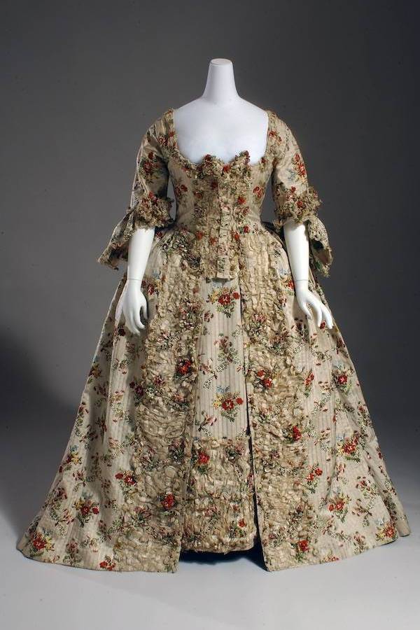 court dress in ivory patterned stripe silk brocaded with multicolor floral and feather bouquets and leopard pattern bows